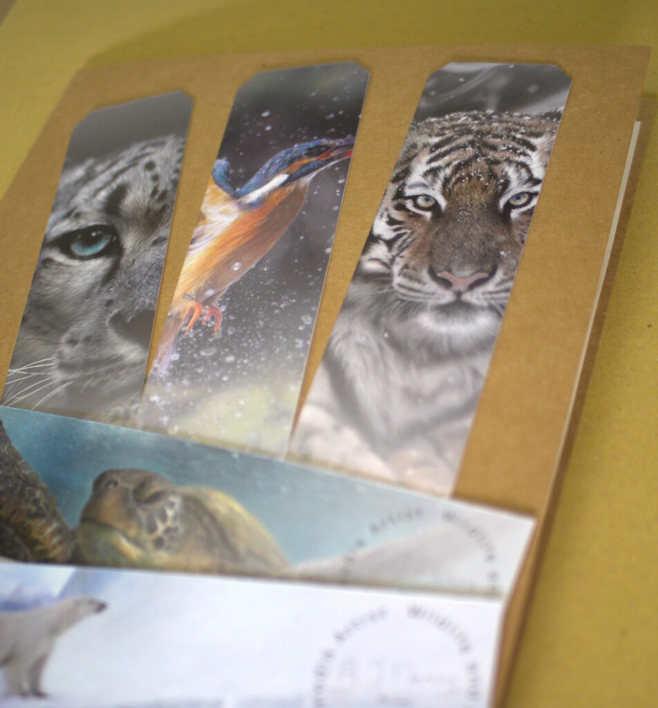 A close-up photo of some little free items (bookmarks in this case) I include when I sell wildlife art